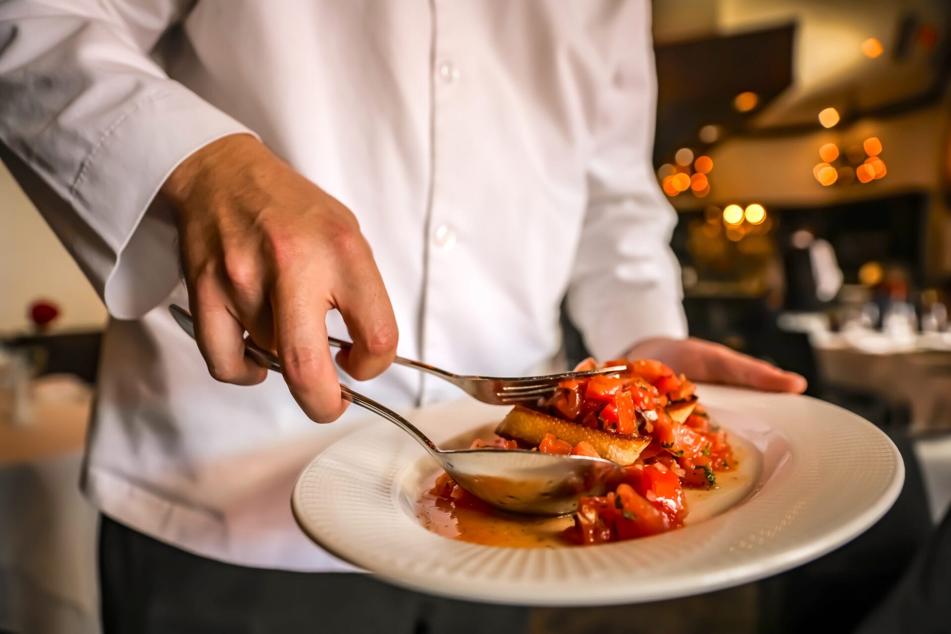 waiter at Il Mulino serving a dish