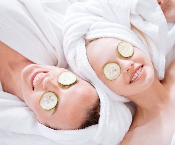 couple relaxing with cucumber eye treatment at spa