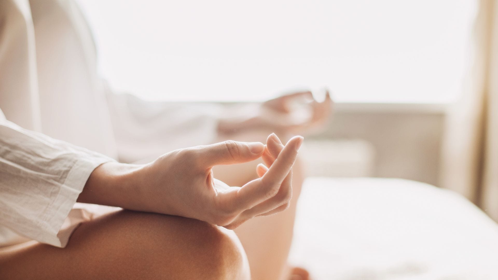 person meditating with hands in mindfulness pose