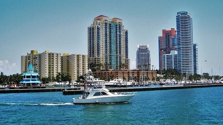 Boat going down the bay with the Miami skyline in the background.